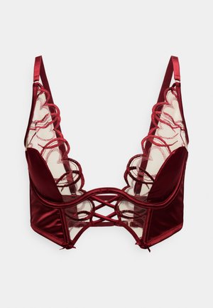 Reggiseno in raso bordeaux con pannelli in mesh trasparente, bordi in pizzo smerlato e dettagli incrociati sul davanti. Spalline regolabili incluse.