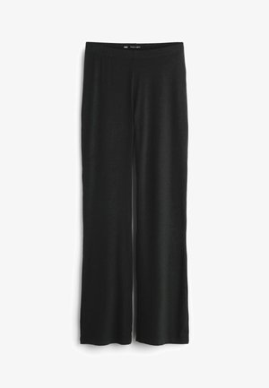 Schwarze weite Hose aus weichem Stoff mit elastischem Bund. Flache Nähte und keine sichtbaren Beschläge. Schlichtes, unaufwendiges Design.