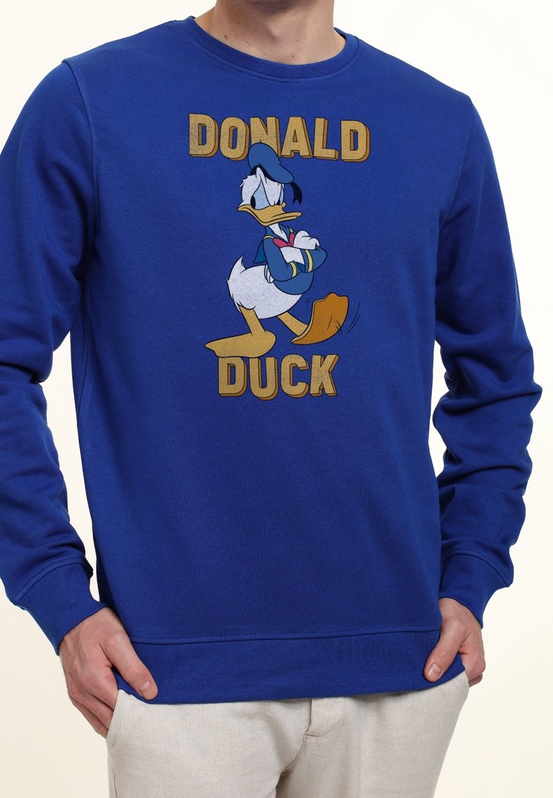 Blue sweatshirt with ribbed cuffs and hem, featuring a front graphic of Donald Duck. Text reads “DONALD DUCK” in gold letters.
