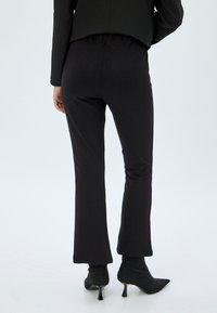 Koton FLARED - Pantaloni - black