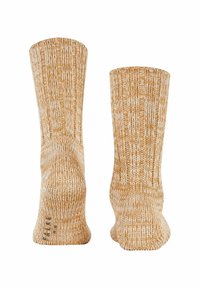 Skarpetki dziane w musztardowym żółtym i kremowym kolorze, z fakturą ryżu. Wzór zawiera lekki obcas oraz bezszwowy czubek dla większego komfortu.