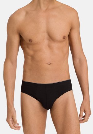 Schwarzes Baumwollslip mit einem tief sitzenden Design, das eine glatte Textur und eine minimalistische einfarbige Optik aufweist. Schlichter Bund mit dezentem Akzent.