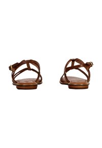 Sandales en cuir marron avec des lanières croisées, une semelle plate et un petit détail de boucle métallique. Texture lisse avec un motif subtil sur la semelle intérieure.