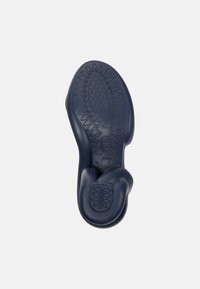 Navy rubber shoe sole with textured grip patterns, curved shape, and size 42 imprint. Features a unique design for comfort and flexibility.