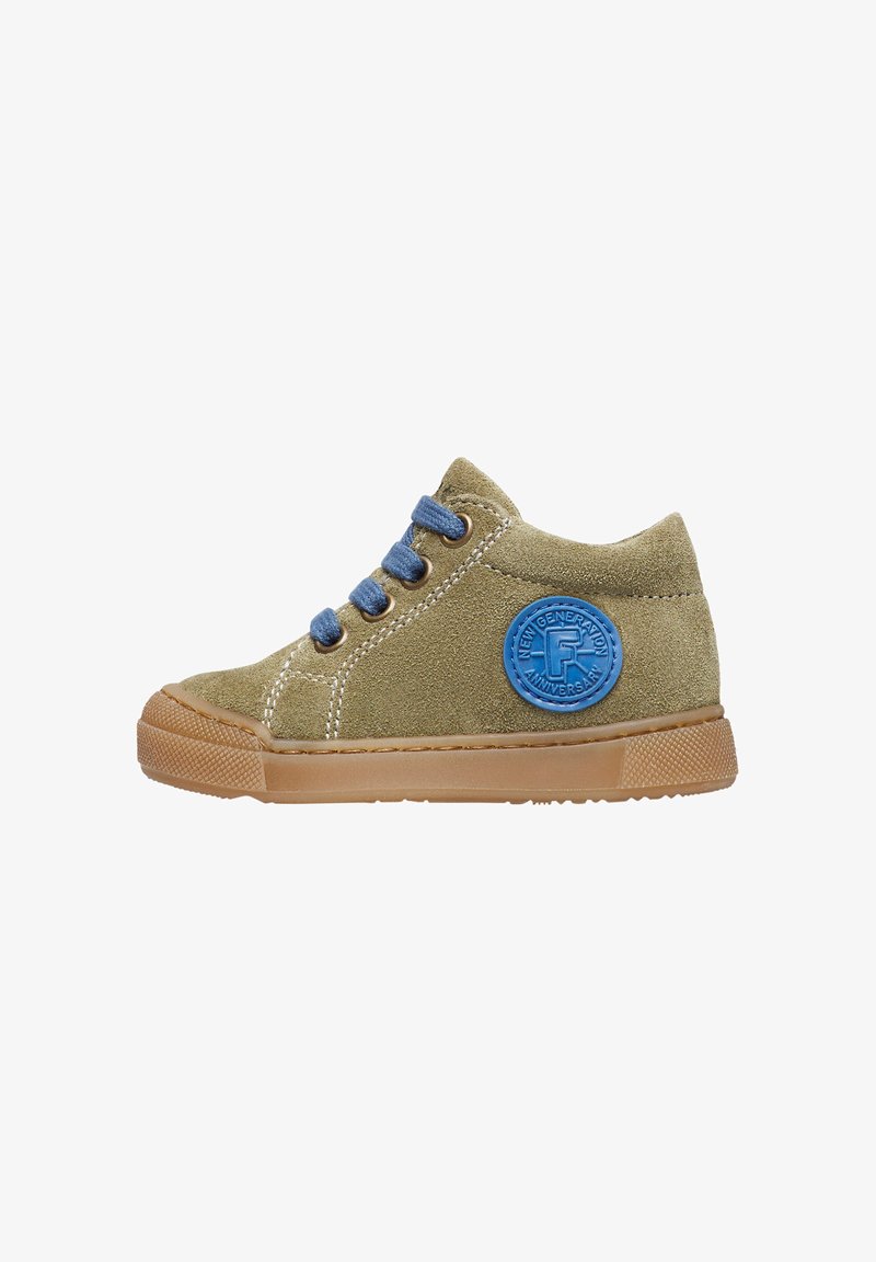 Green suede children's sneaker with blue laces, featuring a round blue patch on the side and a brown rubber outsole. Rounded toe shape.