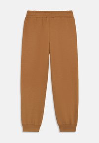 Braune Baumwoll-Jogginghosen mit elastischem Bund, schmal zulaufenden Knöcheln und glatter Textur. Keine sichtbaren Muster oder Hardware-Details.