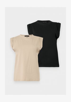 Zwei ärmellose Damenoberteile mit gepolsterten Schultern, eines beige vorne und eines schwarz hinten, beide mit Rundhalsausschnitt und Etiketten.