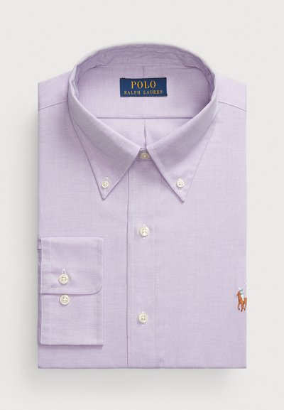 Lavender button-down shirt featuring a classic collar, white buttons, and a small embroidered polo logo on the lower front. Cotton fabric.