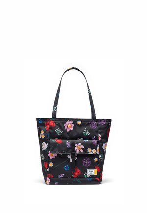 Sac cabas noir avec deux poignées, poche avant à rabat et imprimé floral coloré en fleurs rouges, roses, jaunes, blanches et violettes.