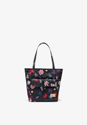 Sac cabas noir avec deux poignées, poche avant à rabat et imprimé floral coloré en fleurs rouges, roses, jaunes, blanches et violettes.