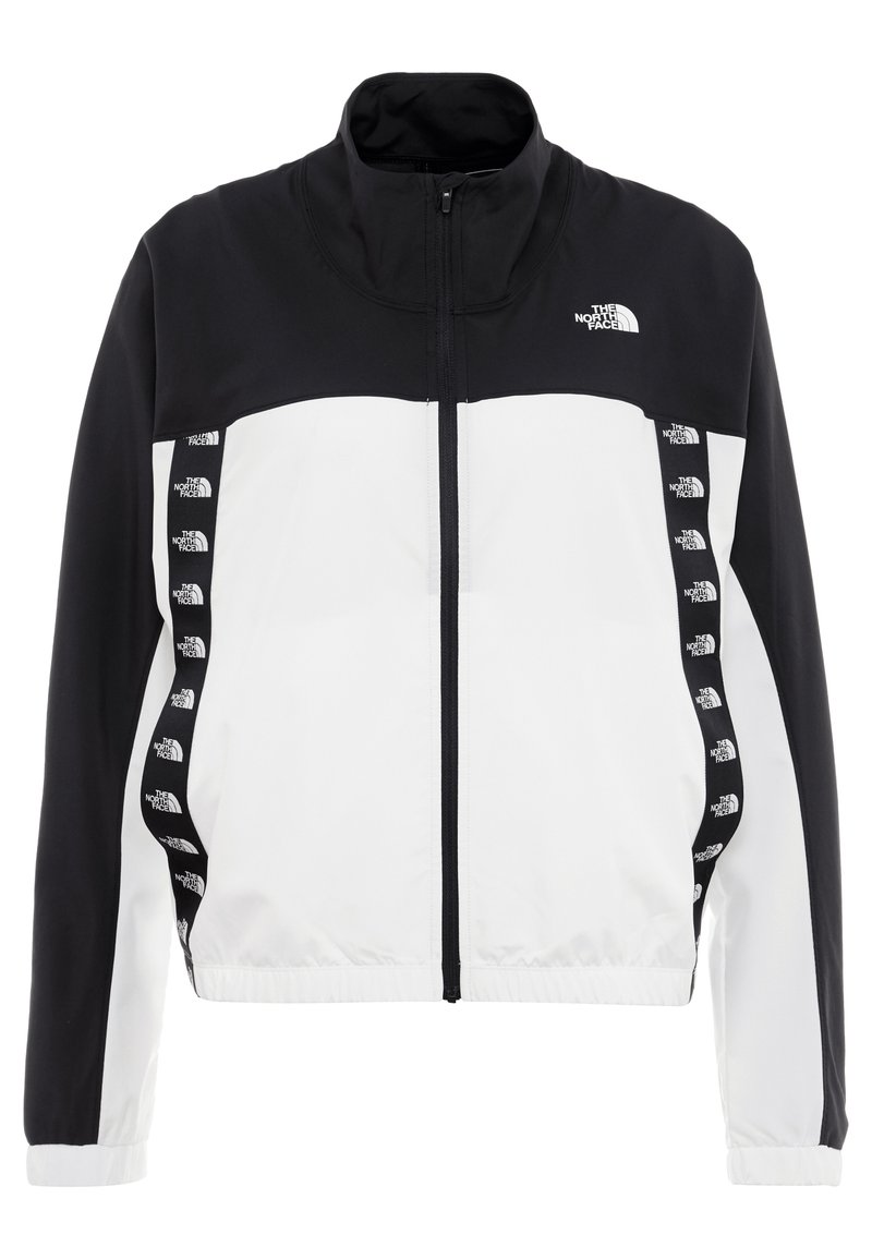 Veste zippée noir et blanc à manches longues, col montant, avec logos The North Face sur la poitrine et les bandes latérales verticales.