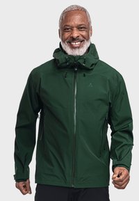 Grüne wasserdichte Jacke mit hohem Kragen, verstellbare Kapuze und Reißverschlusstaschen. Sie hat eine glatte Textur und einen verdeckten Frontreißverschluss.