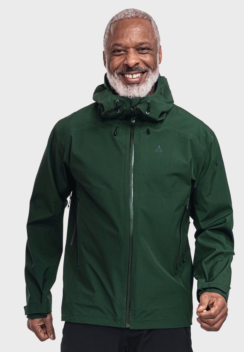 Grüne wasserdichte Jacke mit hohem Kragen, verstellbare Kapuze und Reißverschlusstaschen. Sie hat eine glatte Textur und einen verdeckten Frontreißverschluss.