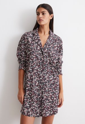 Floral shirt dress featuring a dark background with pink and white flowers, button-front closure, collared neckline, and long sleeves.