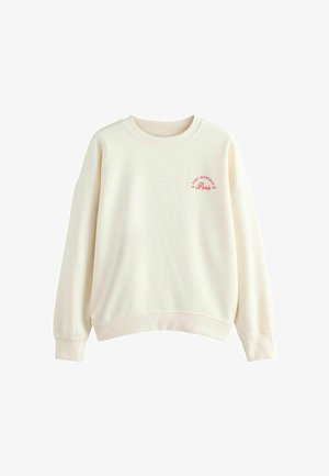 Gaišs bežs džemperis, apaļš kakls, kritušas plecu šuves, ribotas piedurkņu un apakšmalas, ar sarkanu tekstu "PARC MONCEAU Paris 93".