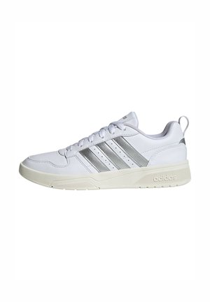 Witte Adidas sneaker met zilveren strepen, veters aan de voorkant, gevoerde zool en een hiel lus, weergegeven in zijaanzicht op een effen achtergrond.