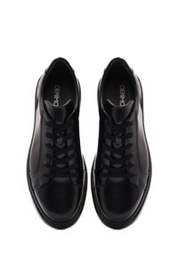 Black leather sneakers with a smooth finish, round toe, and black laces. Features a logo on the insole and subtle stitching details.