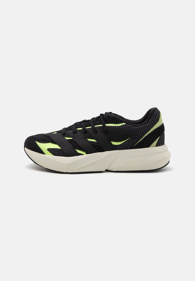 Black athletic shoes with mesh upper, neon green accents, and three black stripes. Lightweight sole, textured details, and contrasting heel.