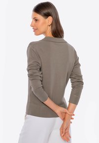 Olivgrüner Pullover mit Kragen, gerippten Bündchen und Saum. Weiche Textur mit schmalem Schnitt, zeigt die Rückansicht.