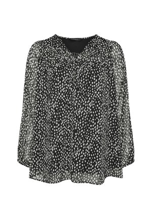 Blusa negra transparente de manga larga con patrón de puntos irregulares blancos, escote fruncido y pequeño detalle de lazo en el frente.