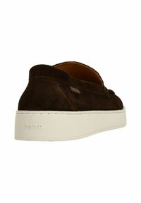 Brown suede slip-on shoe with a textured surface, featuring a white platform sole and a small metal logo accent near the heel.