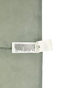 Gray textured fabric with mesh pattern; care label attached. Includes detailed washing instructions and CE marking at the edge.