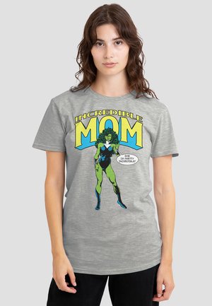 Gray cotton t-shirt featuring a comic-style graphic of a green superhero woman, text reading "INCREDIBLE MOM," and vibrant blue accents.