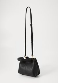 Black leather shoulder bag with a textured finish, cinched top, and adjustable strap. Features gold-tone hardware and a structured shape.
