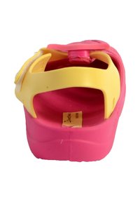 Pink and yellow plastic sandal with a thick sole, adjustable strap, and rounded toe. Features a circular accent on the strap.