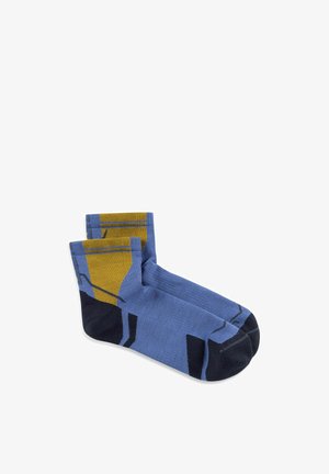 Pair of ankle-length socks in blue with black toes and heels, featuring mustard yellow geometric patterns on the upper sides.