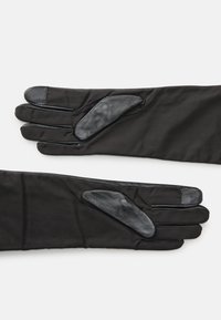 Svarta handskar med en mjuk tygkropp och läderdetaljer på fingrar och handflata, utformade för värme och grepp.