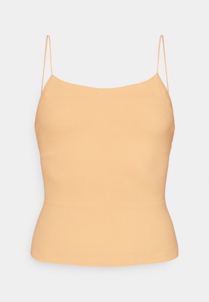 Camisole couleur pêche avec de fines bretelles spaghetti réglables. Coupe ajustée, texture lisse et design simple avec un ourlet légèrement incurvé.