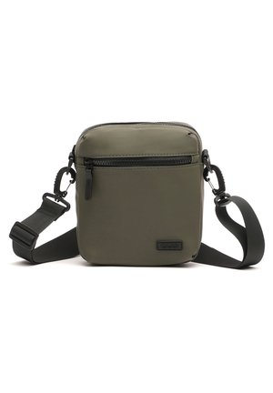 Olive green, square crossbody bag made of smooth, durable material. Features a front zip pocket and adjustable strap for customization.