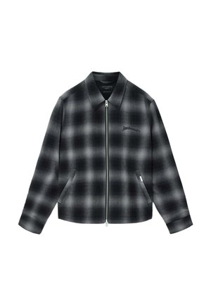 Black and gray plaid jacket with a zip front, pointed collar, and side pockets. Features embroidered logo on the chest and a structured silhouette.