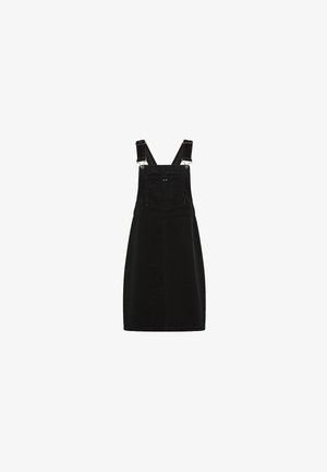 Robe in velluto a coste nera con bretelle regolabili, una tasca frontale e una linea dritta, caratterizzata da dettagli di cucitura sottili.