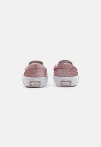 Roza svjetlucava slip-on tenisica s zaobljenim vrhom, unaprijed podstavljeni ovratnik i bijela gumena potplat s "VANS OFF THE WALL" logotipom na peti.