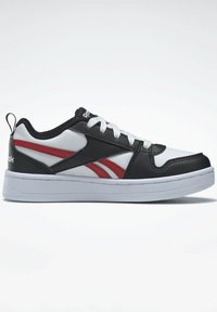 Chaussure de sport noir et blanc avec des accents rouges, tige texturée, fermeture à lacets, semelle en caoutchouc et une tirette au niveau du talon.