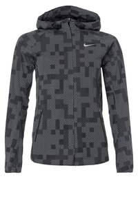 Veste à capuche à motifs noir et gris, dotée d'une fermeture zippée et de poches. Fabriquée en matériau léger avec une texture en mesh.