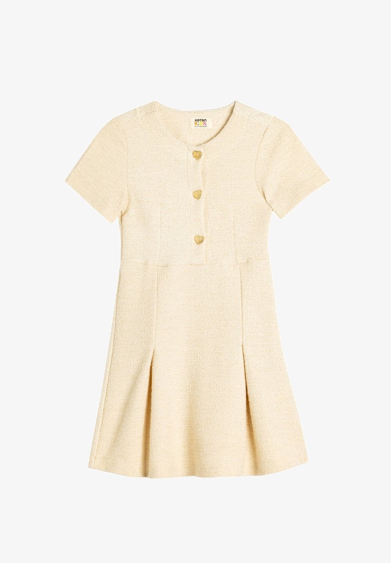 Kurzärmliges A-Linien-Kleid aus strukturiertem beigem Stoff mit rundem Ausschnitt, herzförmigen Knöpfen und einem ausgestellten Rock mit seitlichen Falten.