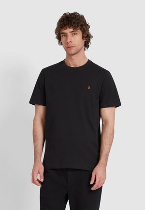 T-shirt in cotone nero con colletto girocollo, maniche corte e un piccolo logo arancione sul lato sinistro del petto. Tessuto morbido, vestibilità classica.