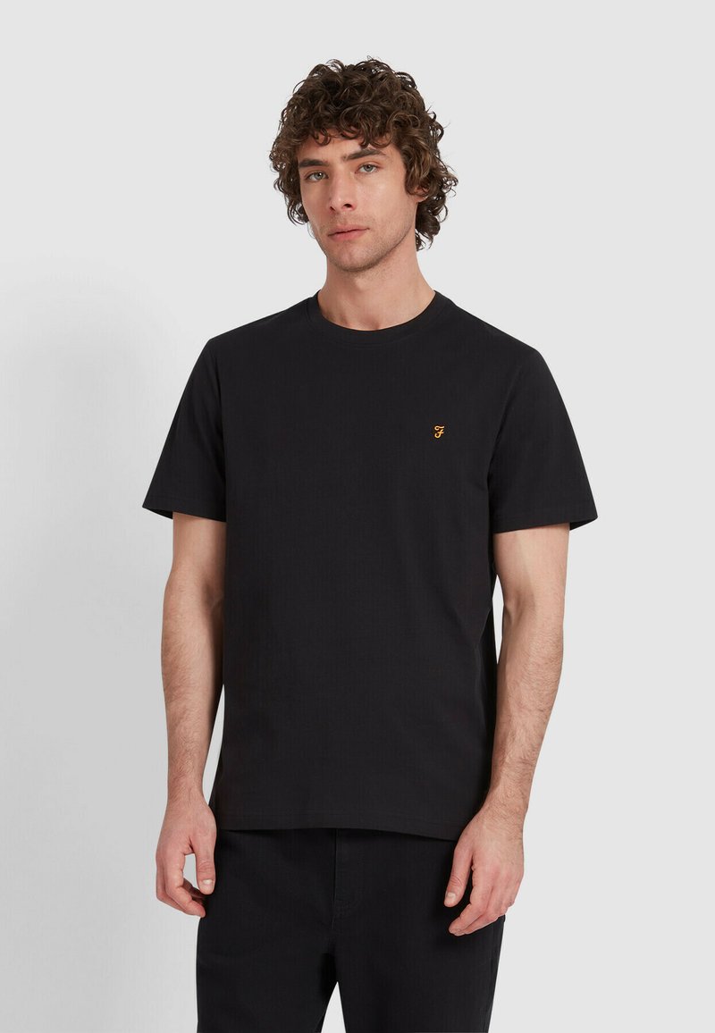 T-shirt in cotone nero con colletto girocollo, maniche corte e un piccolo logo arancione sul lato sinistro del petto. Tessuto morbido, vestibilità classica.