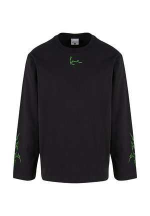 Zwarte langslavige T-shirt van katoen, met groene grafische details op de borst en mouwen. Ronde hals, ontspannen pasvorm.