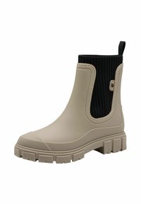 Bottine en caoutchouc beige avec une semelle épaisse et un panneau en tissu extensible noir à côtes autour de la cheville, doté d'une languette à l'arrière.