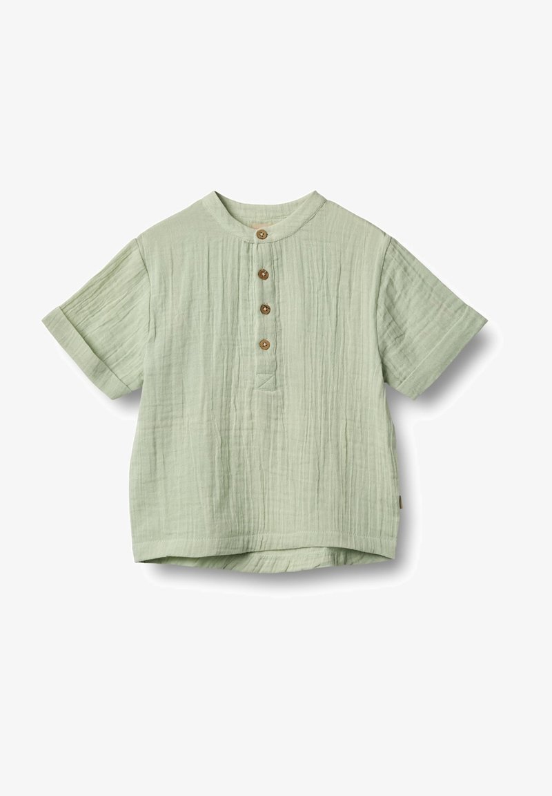 Lysegrøn kortærmet skjorte lavet af tekstureret stof, med rund halsudskæring og fire træknapper fortil.