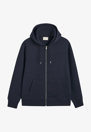 Navy zip-up hoodie made of soft fabric with a hood, front pockets, and GANT logo embossed on the left chest. Smooth texture.