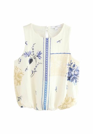 Ærmeløs cremefarvet bluse med blå og beige blomsterbroderi, lodret blåmønstret kant ned ad midten og lukkes bagpå med knapper.
