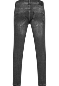 Uske slim-fit crne traperice s izblijelim završetkom, pet džepova i kožnom oznakom na struku. Glatka tekstura i suženi nogavice.