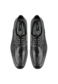 Schwarze Leder- schuhe mit glattem Finish, runder zehenform und subtilen stikdetails. Verfügt über ein schnürdesign und weiche innenauskleidung.