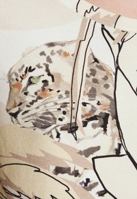 T-paita, jossa on vaalea beige kangas, jossa on harmaalla, mustalla ja vihreällä sävyllä painettu leopardi kuvio, jota korostaa ribattu rakenne.