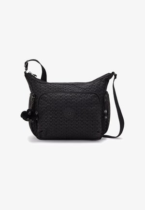 Black textured crossbody bag featuring a geometric pattern, a front zip pocket, a round logo patch, and a pom-pom accent.
